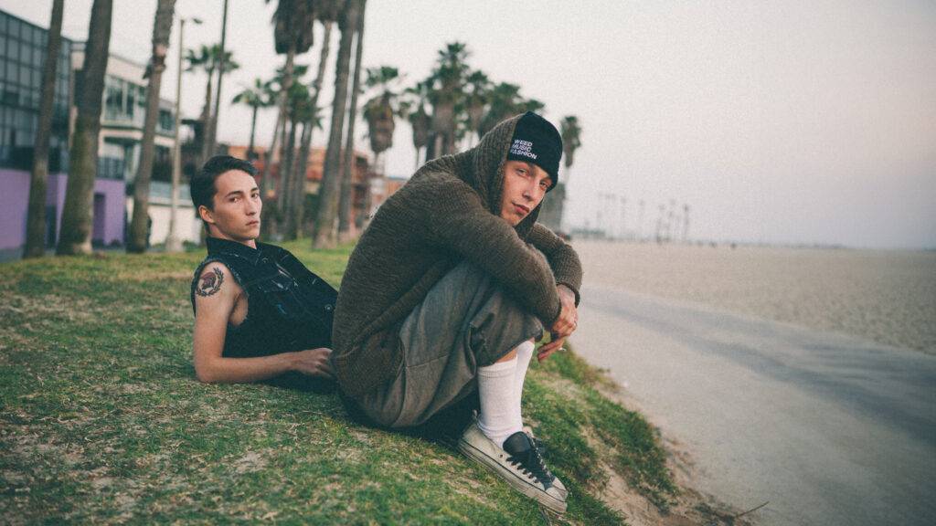 Two male models sitting in Venice Beach by Walid Azami